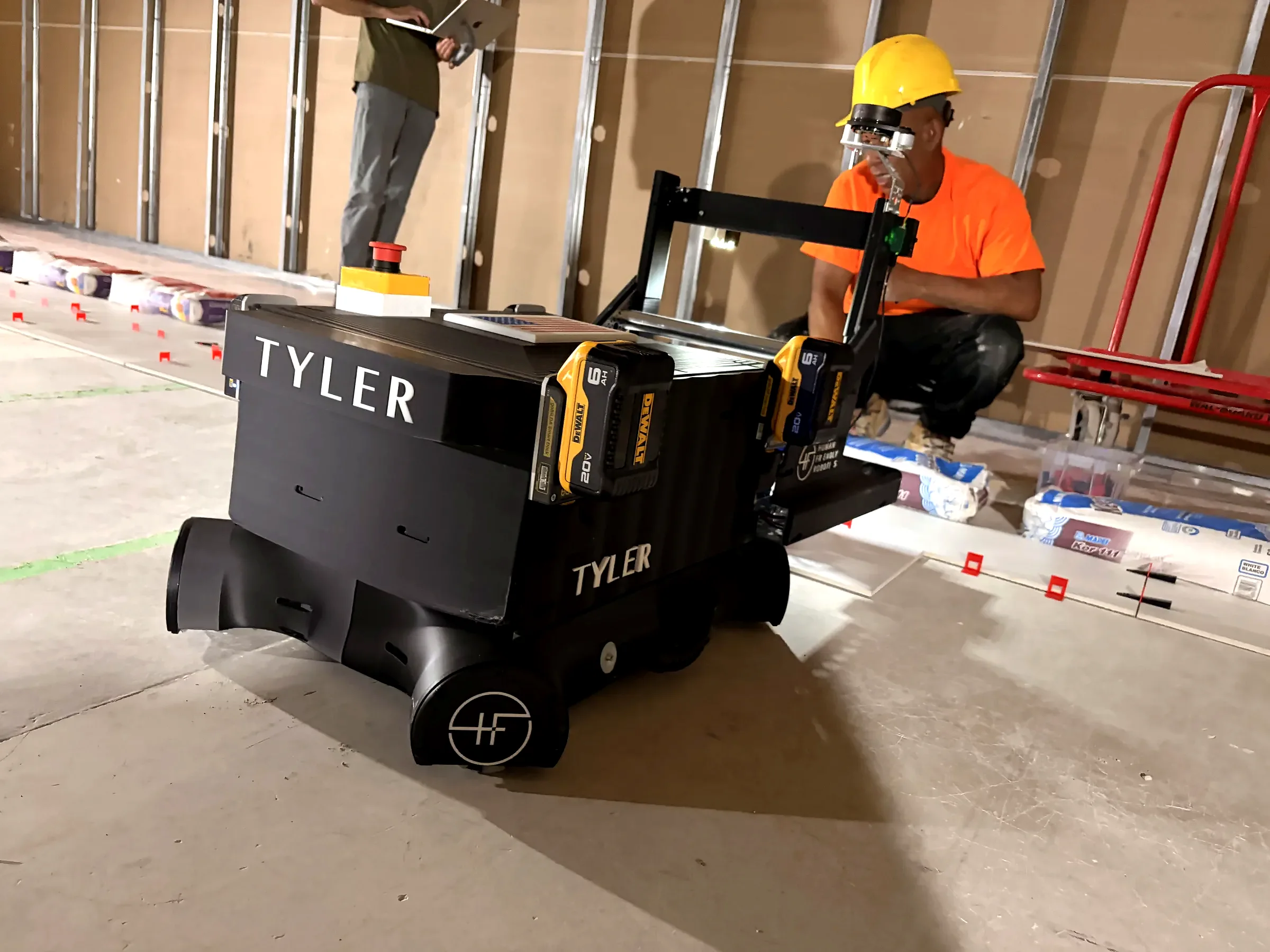 Tyler installing flooring alongside a crew on a live jobsite